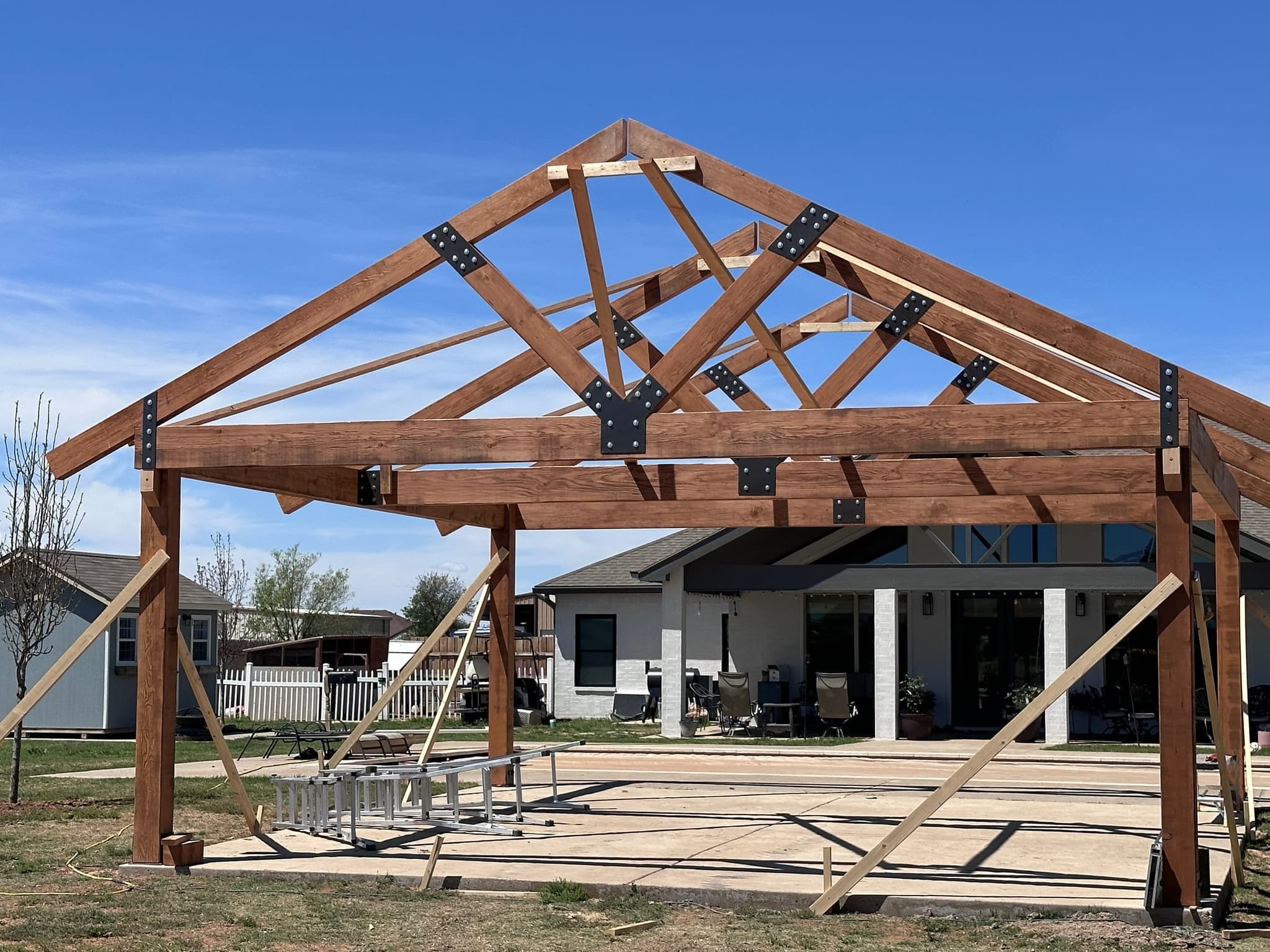 Pavilion frame raised and braced, joints plated and bolted