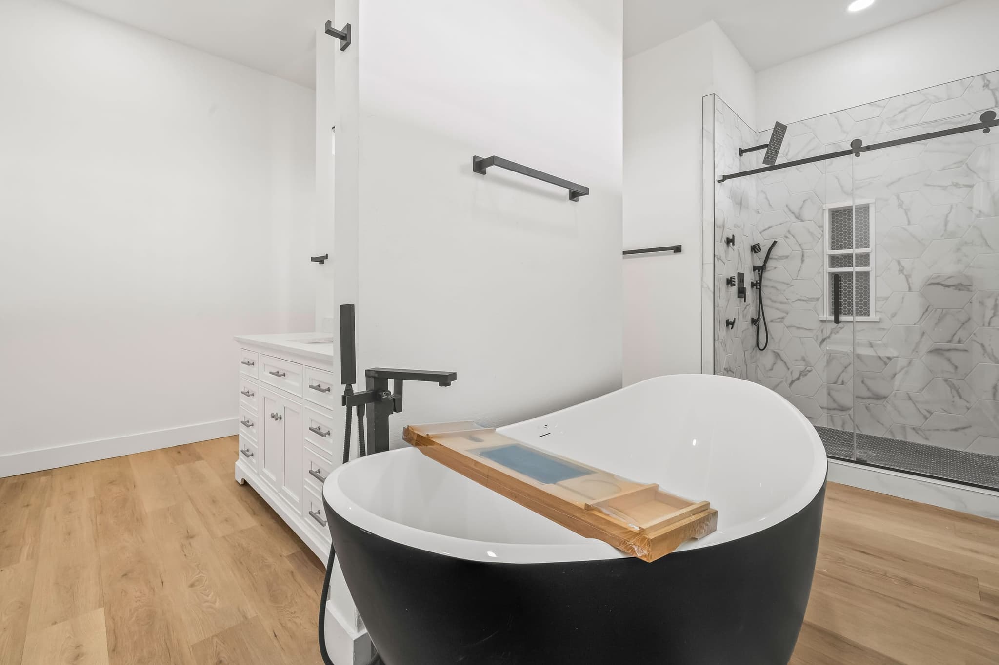 Primary bath with a freestanding tub and walk-in tile shower