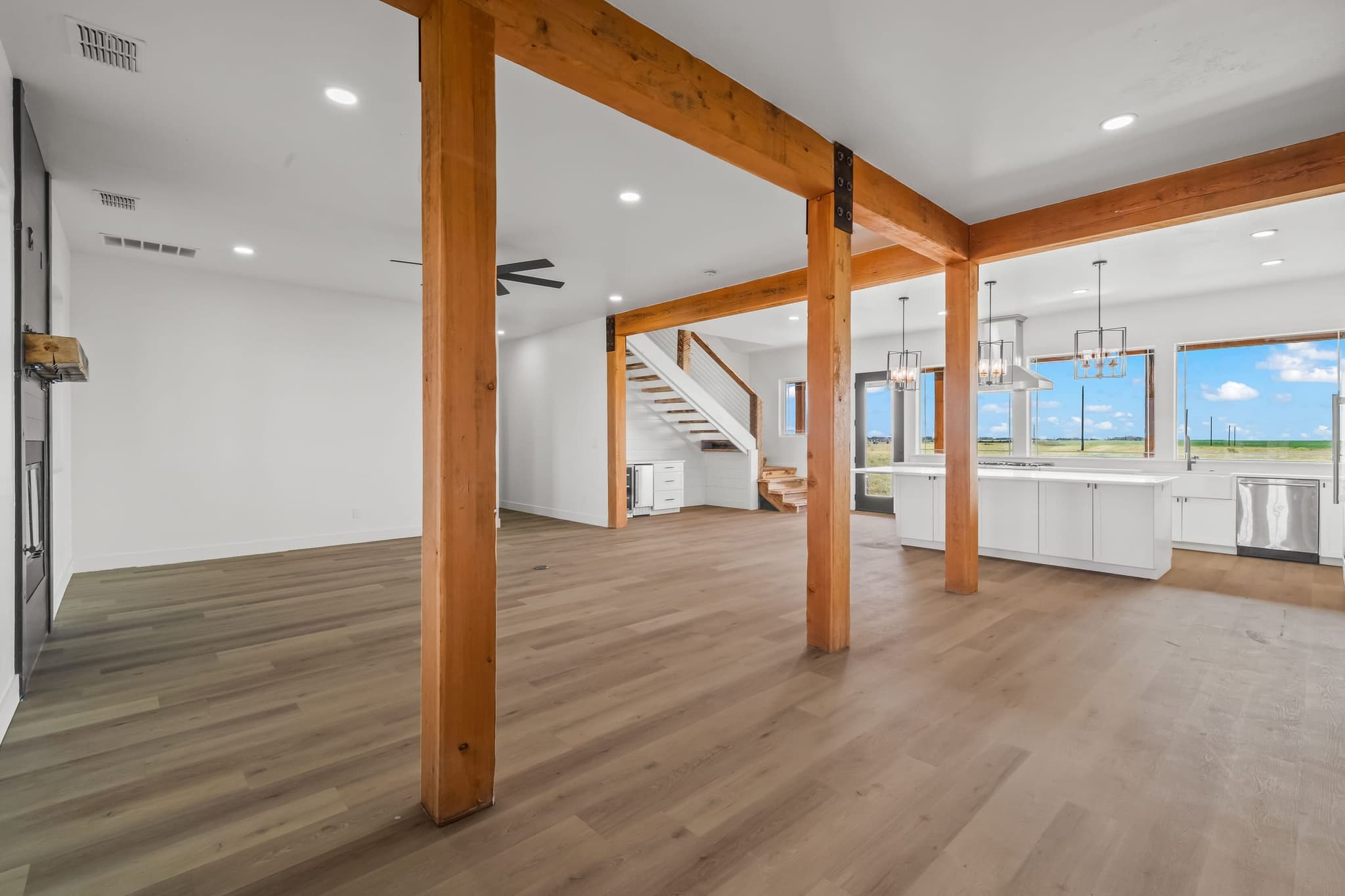 Great room with timber columns and steel plates carrying the span