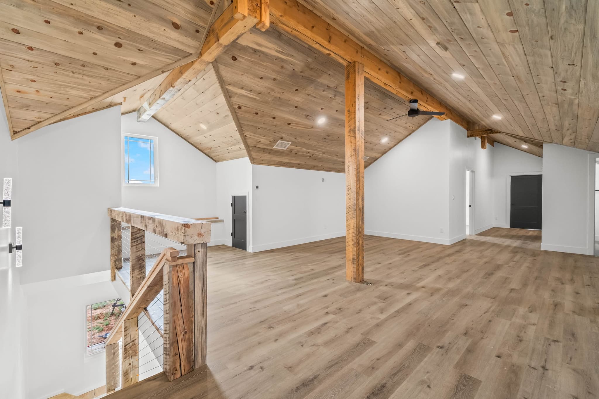 Upstairs loft under a reclaimed timber ceiling