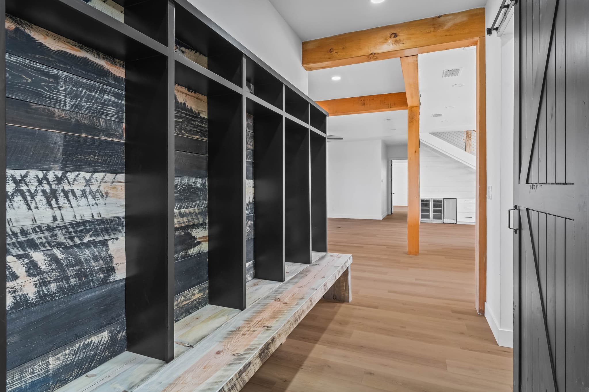 Mudroom lockers on a charred and whitewashed board wall