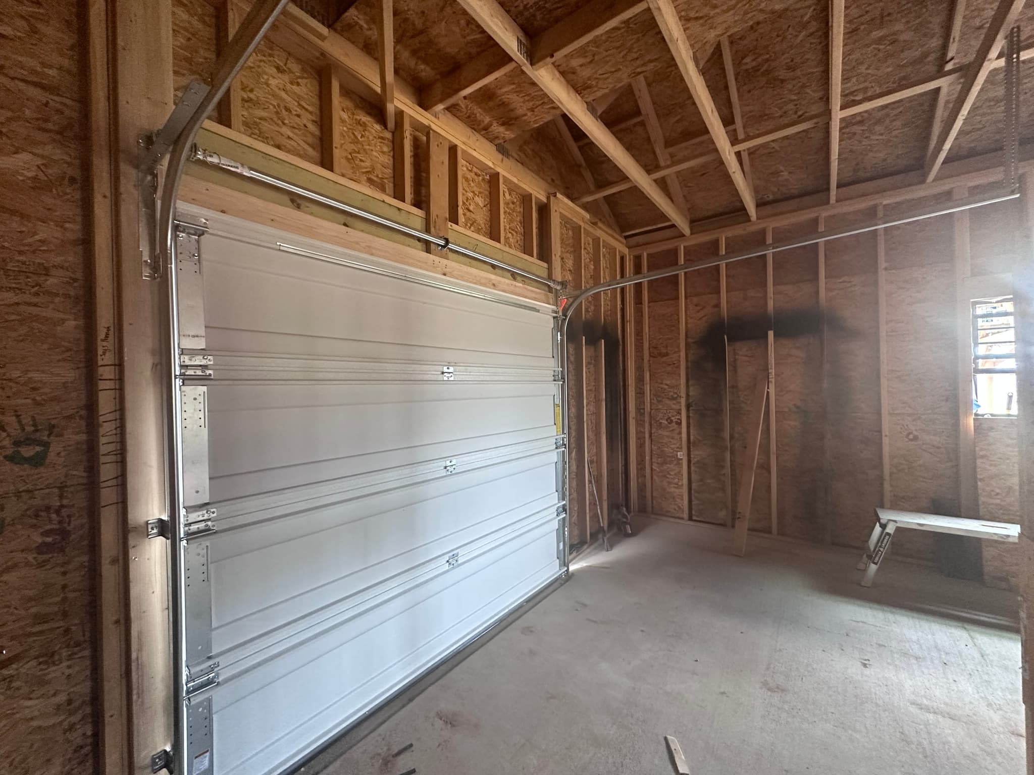 Shop interior with the overhead door hung and open bays