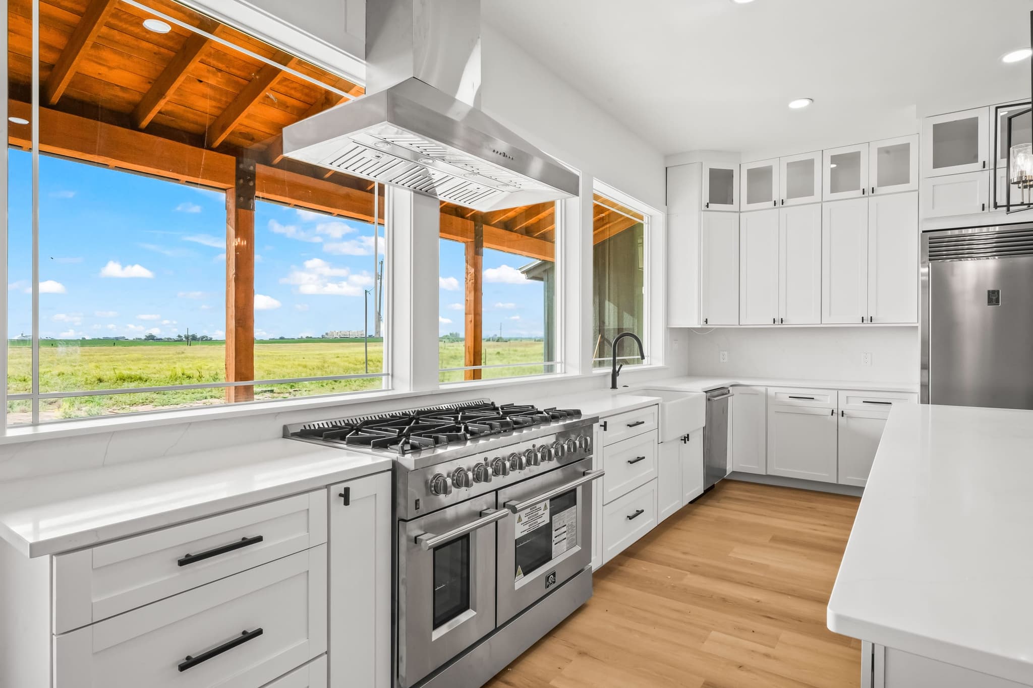 Timber frame porch seen from inside the kitchen, framing the view